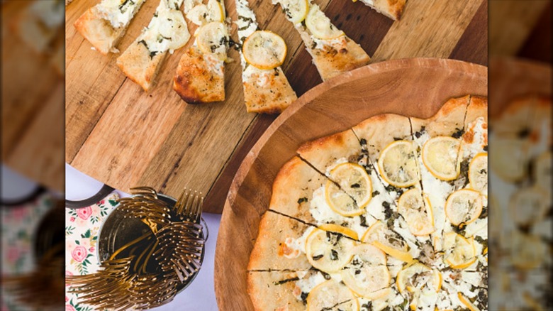 Lemon with ricotta and herbs on pizza