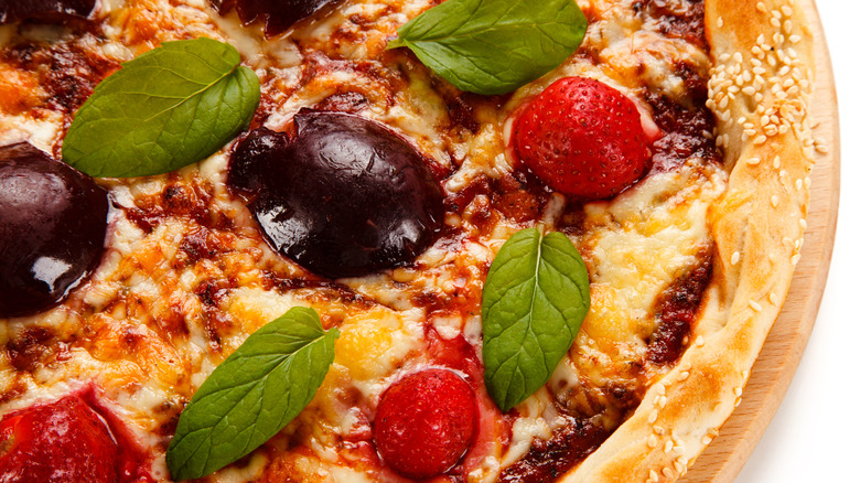 Plum pieces on pizza