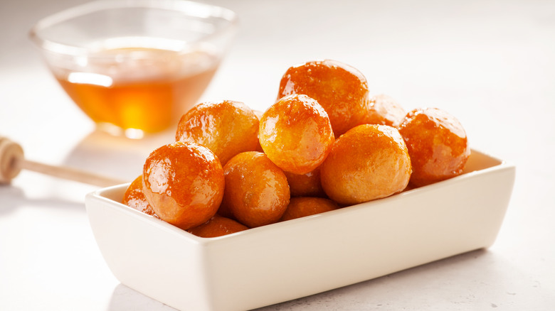 A bowl of honey-glazed loukoumades