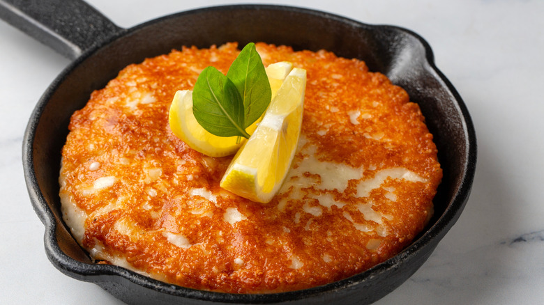 Crispy fried cheese in a small cast iron pan