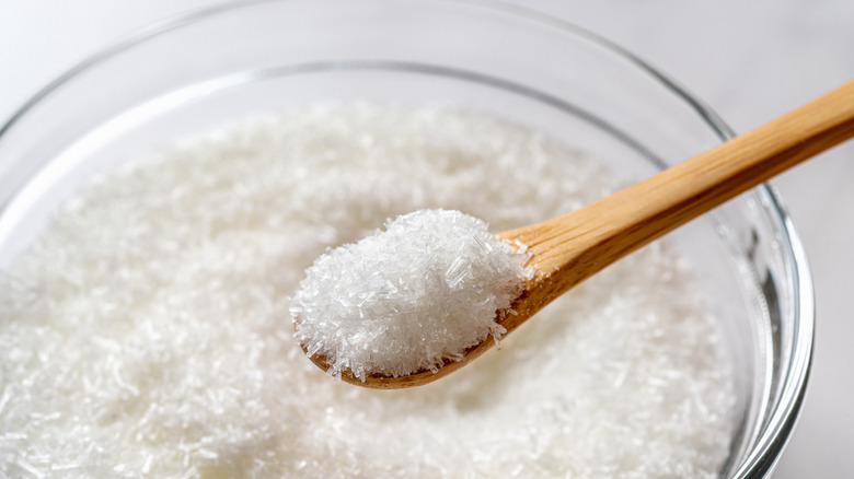 Close-up of bowl of MSG crystals and wooden spoon
