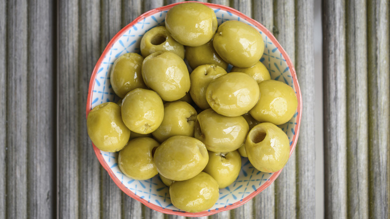 Green olives in a dish