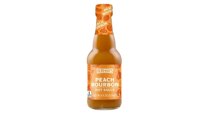 An orange bottle of peach bourbon hot sauce