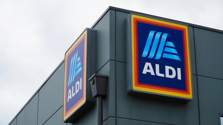 Aldi building viewed from the corner with two Aldi logo signs visible