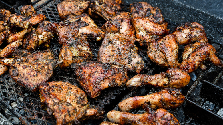 Jerk chicken cooking on a grill