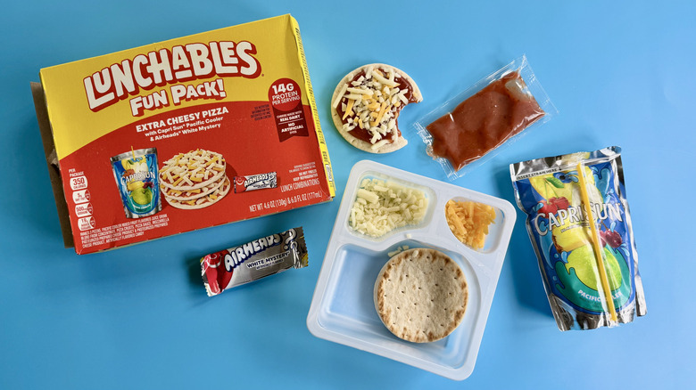 Extra Cheesy Pizza Fun Pack's components on a blue surface
