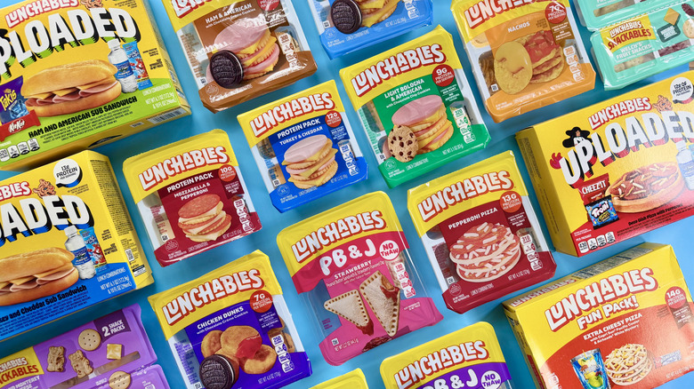 Assorted Lunchables in their packaging on a blue surface