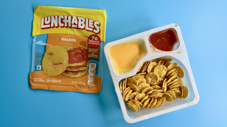 Nachos Lunchables in the opened package on a blue surface
