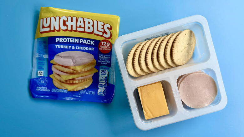 Turkey & Cheddar Protein Pack, opened, on a blue surface