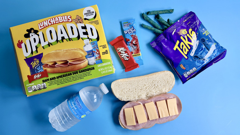 Uploaded Ham and American Sub with all food items on a blue surface