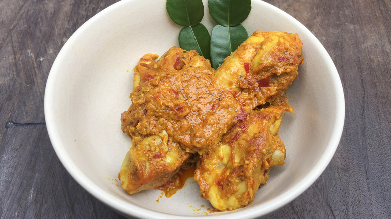 A plate of kari kapitan on a table.