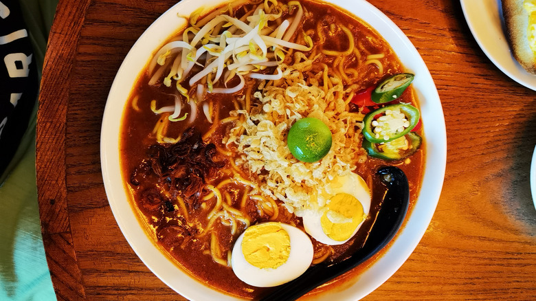 A bowl of mee rebus on a table.