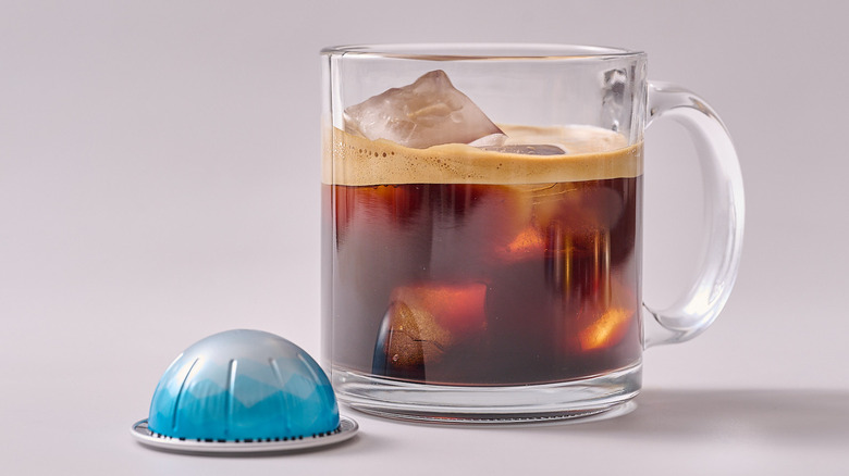 Ice Leggero Nespresso pod and glass of coffee on white table
