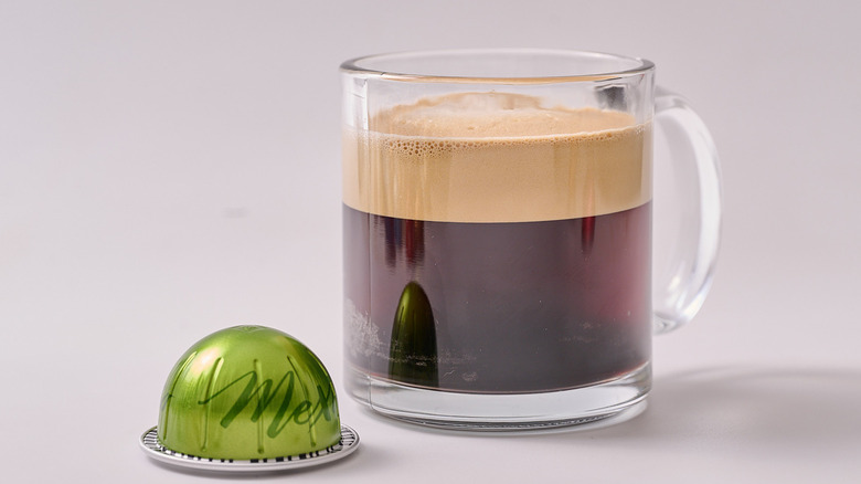 Mexico Nespresso pod and glass of coffee on white table