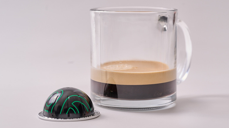 Samra Origins Togetherness Blend Nespresso pod and glass of coffee on white table