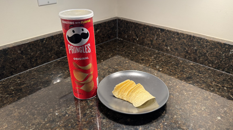 Pringles can on countertop with chips