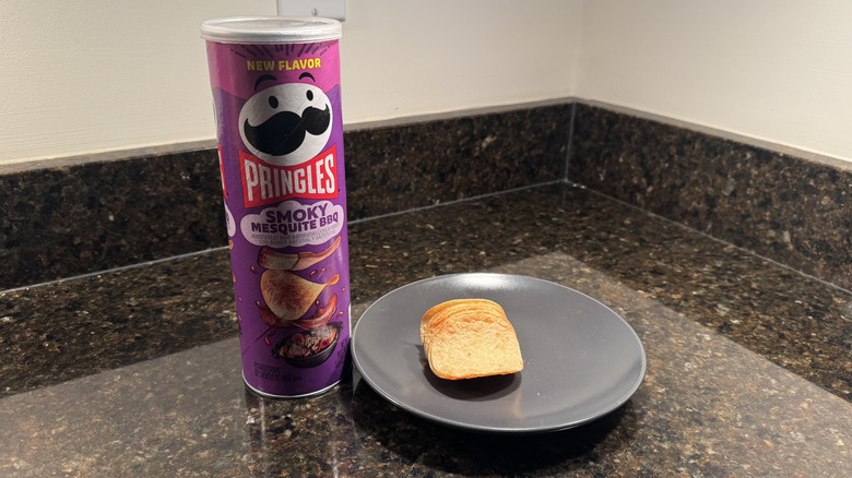Pringles can on countertop with chips on a plate