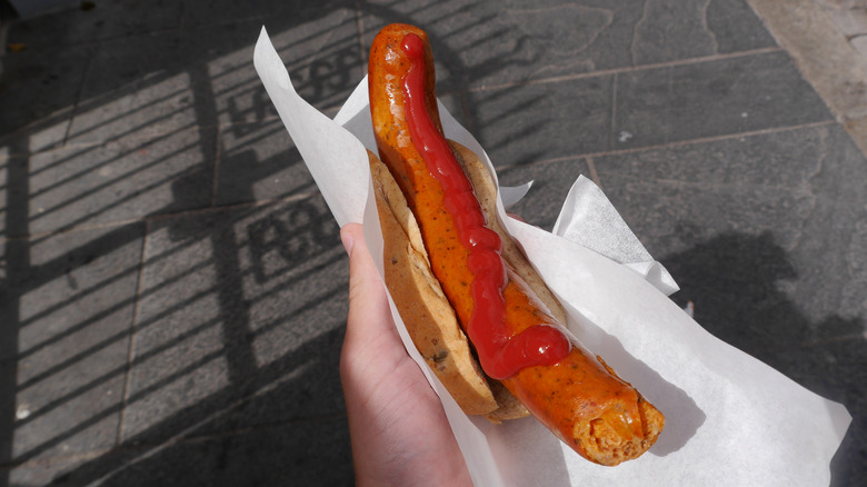 A person holding a pølse in Norway