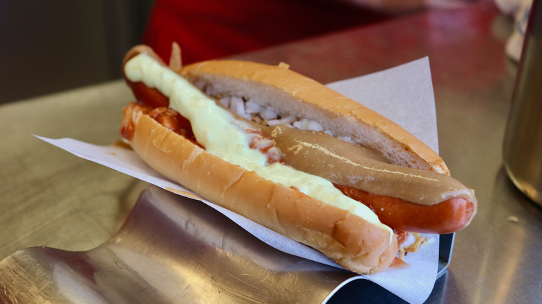 A pylsur hot dog on a metal holder