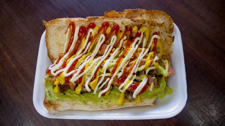A shuco hot dog on a styrofoam plate