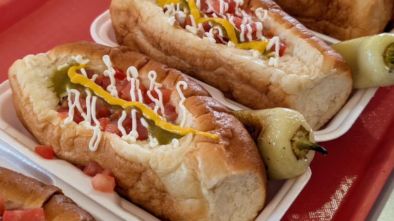 Two Sonoran hot dogs with roasted chiles