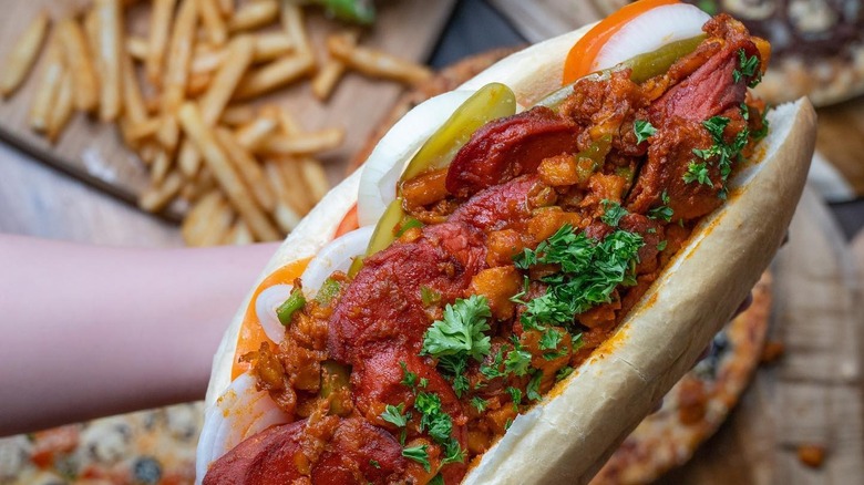 A person holding a sosis bandari