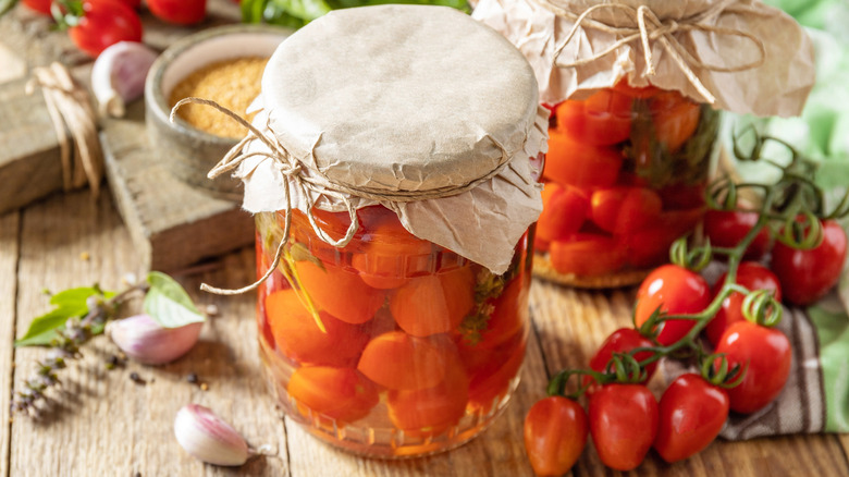 fermented tomatoes in jar on wood counter