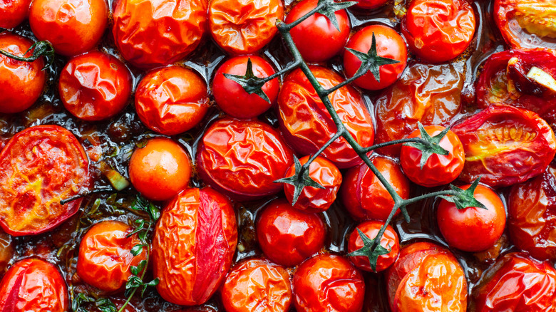 roasted tomatoes arranged closely on sheet pan