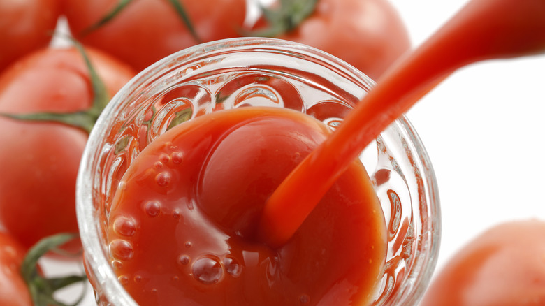 tomato broth pouring into a glass