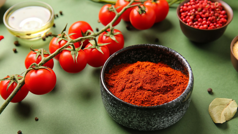 tomato powder in bowl with tomatoes on vine