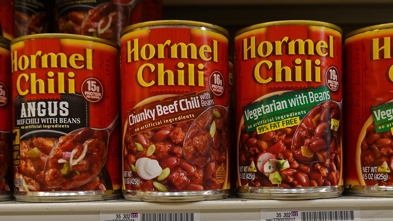 Canned beans and chili on a shelf