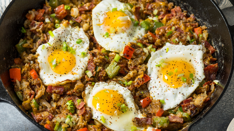 Breakfast hash in a bowl with eggs