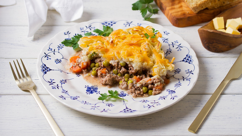 Shepherd's pie on a plate with utensils