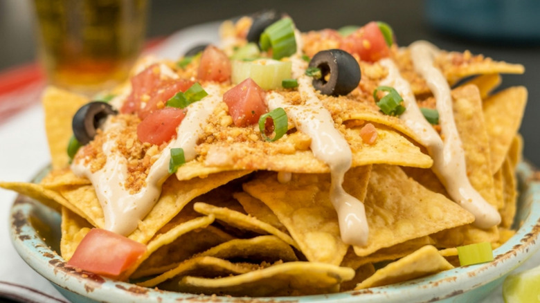 Plate of nachos with toppings