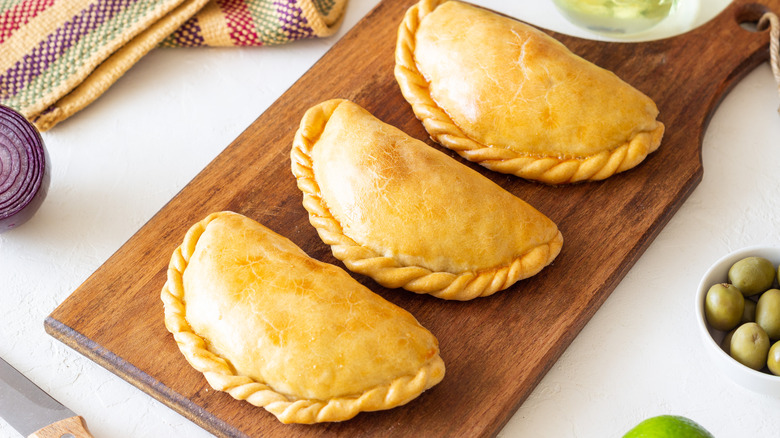 Baked empanadas on a board