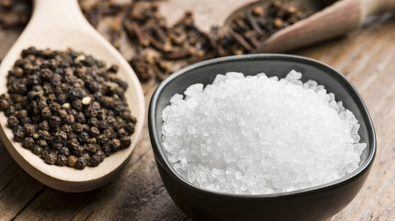 Salt and pepper in bowls on a table