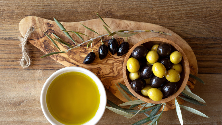 Infused olive oil with herb sprigs and dish