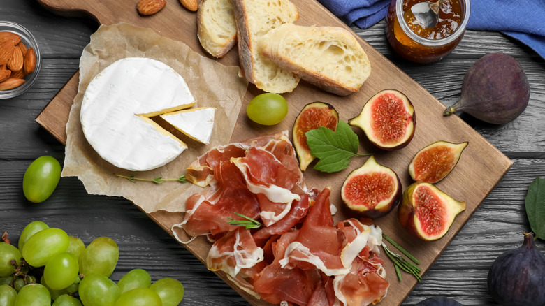 Meat, cheese, and figs on a charcuterie board