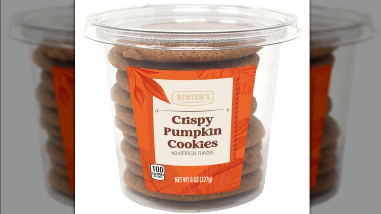 Plastic container of a stack of Benton's Crispy Pumpkin Cookies
