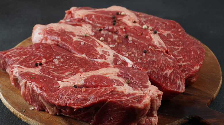 Chuck steak on a wood background