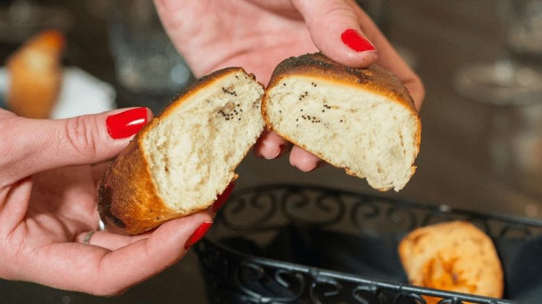 A person holding a bread roll at Palermo Argentinian Bistro