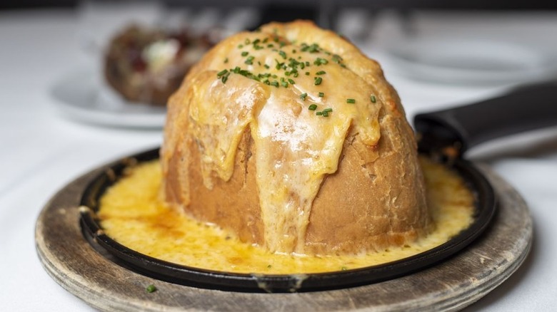 A loaf of cheese bread in a skillet at Osso Steakhouse