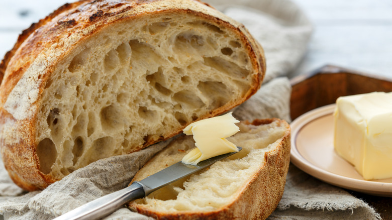 A loaf of sourdough bread with butter