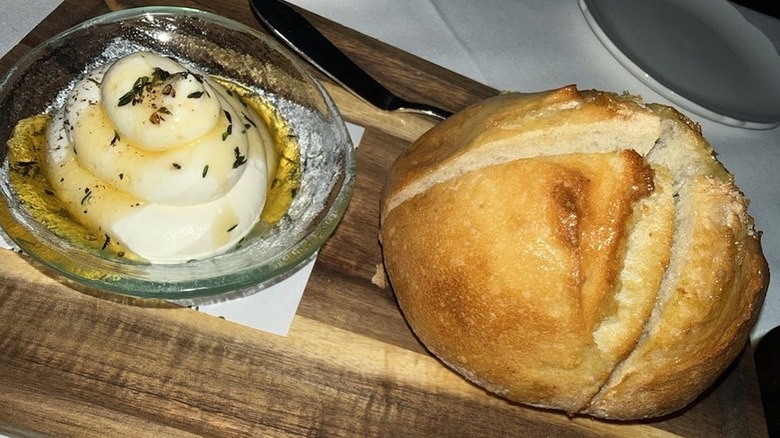 A loaf of sourdough with whipped ricotta, honey, and thyme at Daniel's Miami