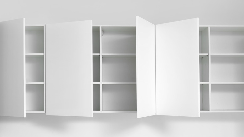 empty white cabinets with open doors