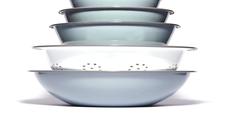 stack of four nested light blue bowls