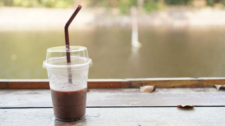 Molten lava cake dirty soda in plastic cup with a straw