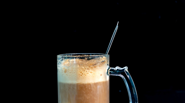 Root beer float dirty soda in a glass mug