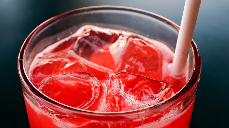 Close up of strawberry shortcake dirty soda in a glass with a straw