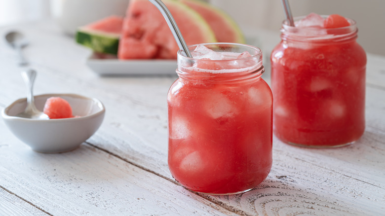 Summer fantasy dirty soda with fresh watermelon in glass mason jar mugs